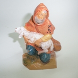 Hirte kniend mit Schaf